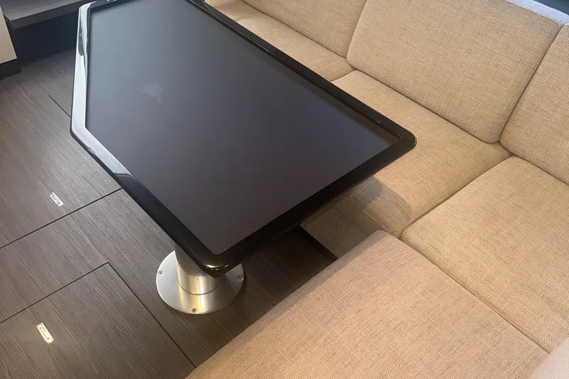  Yacht Photos Pics Interior of 2021 Azimut Verve 47 yacht with modern table and beige seating.