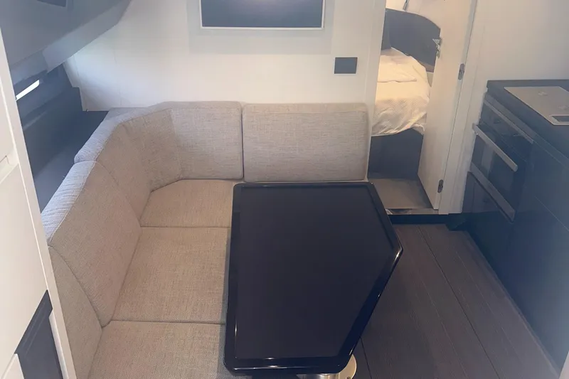  Yacht Photos Pics 2021 Azimut Verve 47 interior with beige seating and modern table.