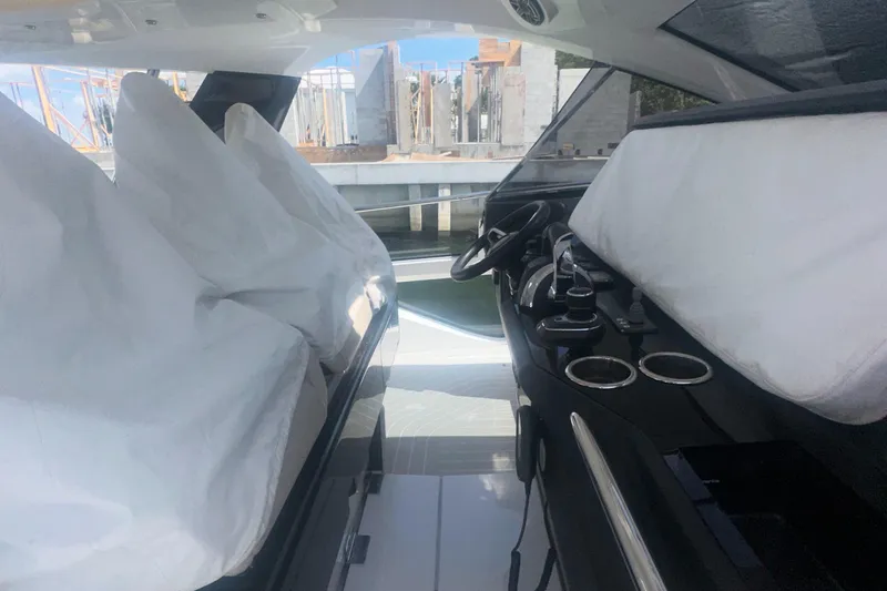  Yacht Photos Pics 2021 Azimut Verve 47 yacht interior with covered seats and modern dashboard.