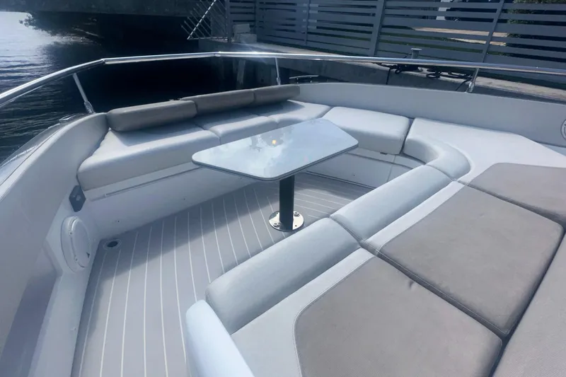  Yacht Photos Pics 2021 Azimut Verve 47 yacht with sleek seating and table on deck.