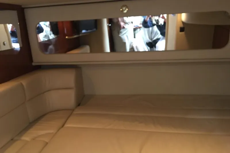 Cap'n Belle Yacht Photos Pics Interior of 2002 Sea Ray 410 Sundancer yacht with beige seating and mirror.