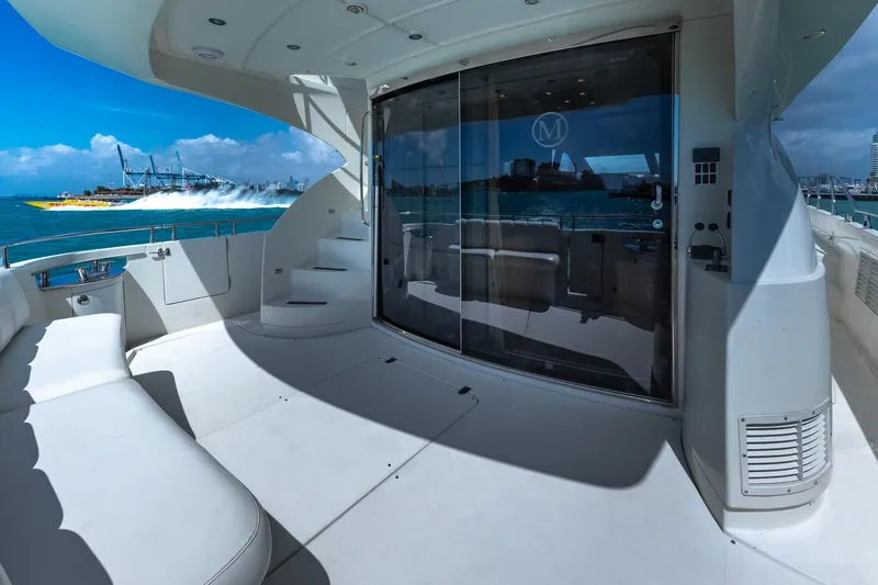  Yacht Photos Pics Luxurious 2005 Marquis 59 yacht deck with ocean view and speedboat in background.
