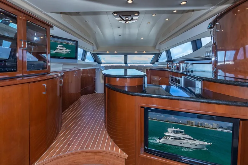  Yacht Photos Pics Luxurious interior of a 2005 Marquis 59 yacht with elegant wood finishes and modern amenities.