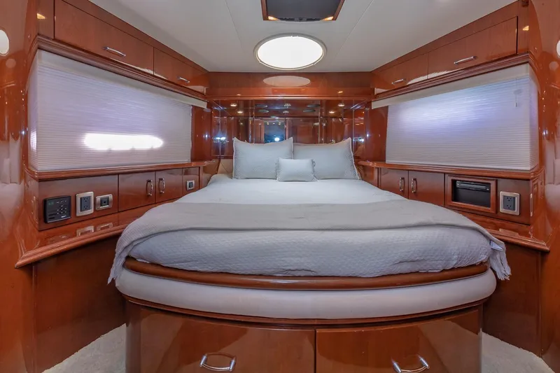  Yacht Photos Pics Luxurious 2005 Marquis 59 yacht bedroom with elegant wood finish and cozy bedding.