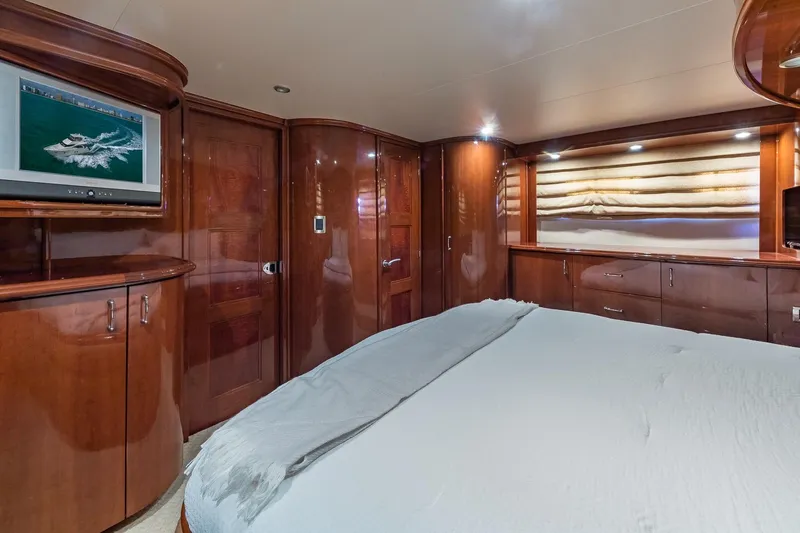  Yacht Photos Pics Luxurious 2005 Marquis 59 yacht bedroom with wood paneling and TV.