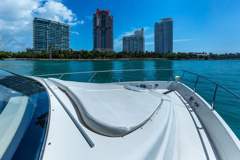  Yacht Photos Pics Luxury yacht Marquis 59 cruising near modern city skyline, 2005 model.