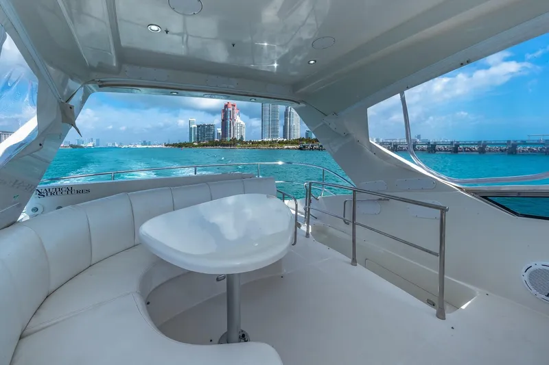  Yacht Photos Pics Luxurious 2005 Marquis 59 yacht interior with ocean view and city skyline in the background.