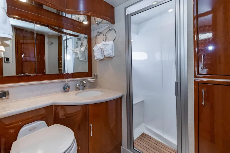  Yacht Photos Pics Luxurious 2005 Marquis 59 yacht bathroom with wood cabinetry and modern shower.
