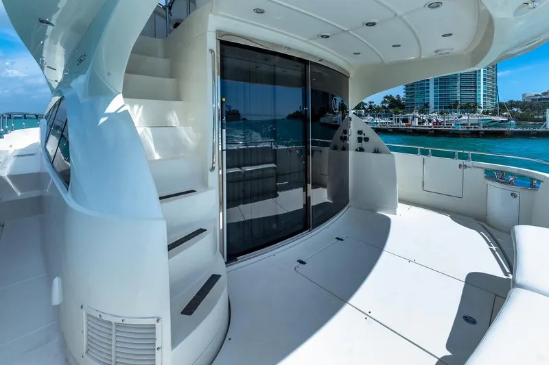  Yacht Photos Pics Luxurious 2005 Marquis 59 yacht deck with stairs and waterfront view.