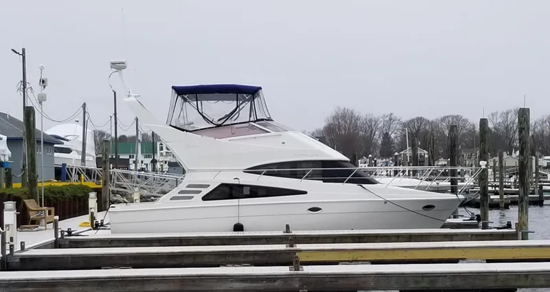 Sea Questah Yacht Photos Pics 2007 Carver 35 Super Sport yacht docked at a marina on a cloudy day.