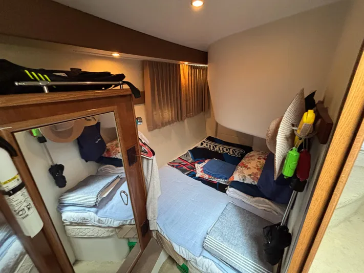 Sea Questah Yacht Photos Pics Cozy cabin interior of 2007 Carver 35 Super Sport with bed and storage.