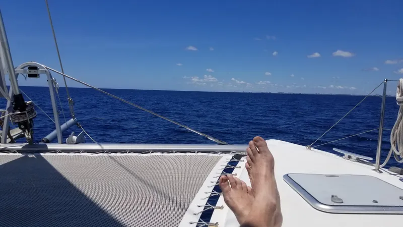 The Next Thing Yacht Photos Pics Relaxing on a 2010 Lagoon 400 catamaran, enjoying the open sea and clear blue sky.