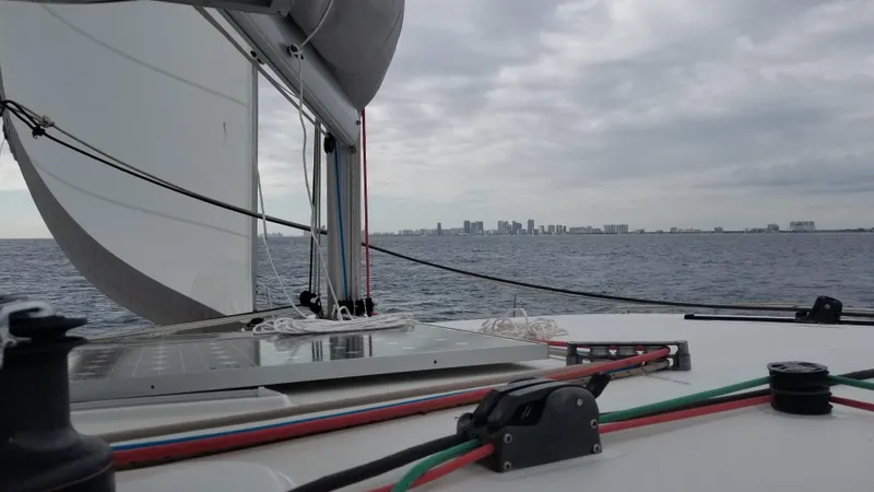 The Next Thing Yacht Photos Pics Sailing on a 2010 Lagoon 400 catamaran with city skyline in the distance.