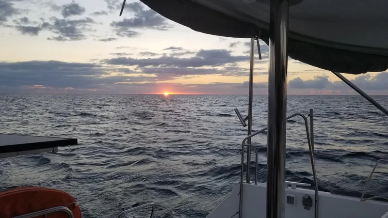 The Next Thing Yacht Photos Pics Lagoon 400 sailboat at sea during sunset, 2010 model.