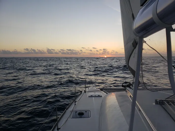 The Next Thing Yacht Photos Pics Lagoon 400 sailboat at sunset on the ocean, 2010 model.