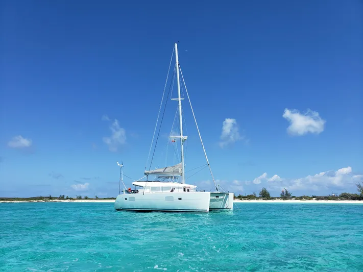 The Next Thing Yacht Photos Pics 2010 Lagoon 400 catamaran sailing in clear turquoise waters under a bright blue sky.