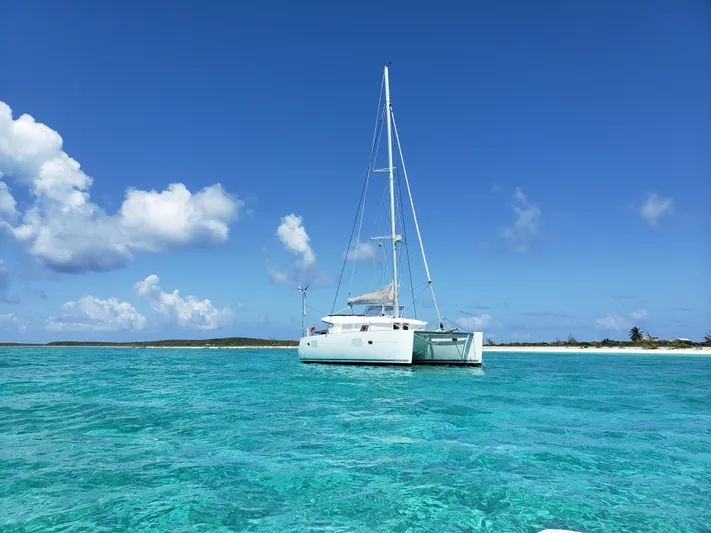 The Next Thing Yacht Photos Pics Lagoon 400 catamaran anchored in clear turquoise waters, 2010 model.
