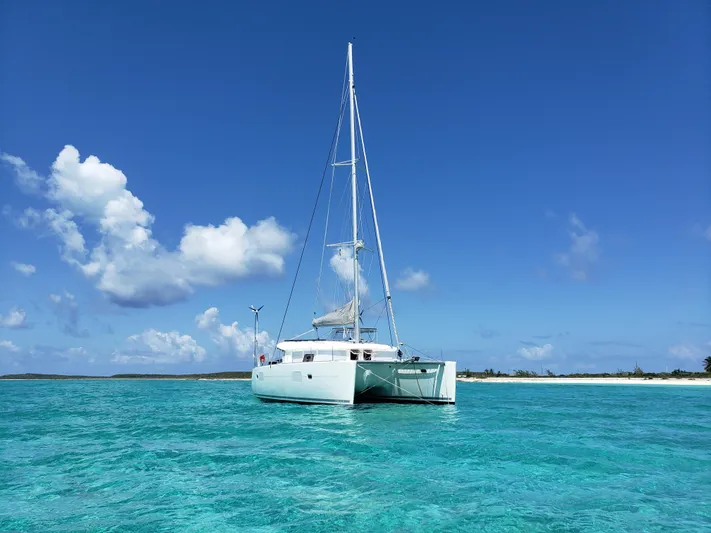 The Next Thing Yacht Photos Pics Lagoon 400 owner's version catamaran sailing in clear turquoise waters, 2010 model.