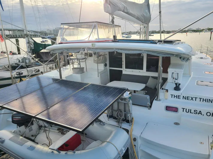 The Next Thing Yacht Photos Pics 2010 Lagoon 400 owner's version catamaran with solar panels docked at marina.
