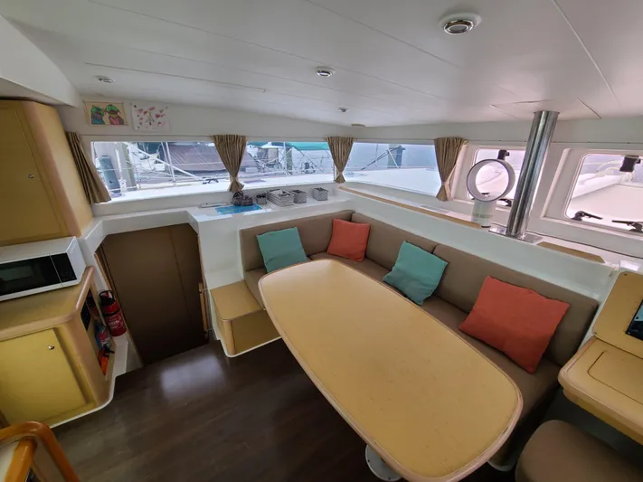 The Next Thing Yacht Photos Pics Interior of 2010 Lagoon 400 owner's version catamaran with cozy seating and colorful cushions.