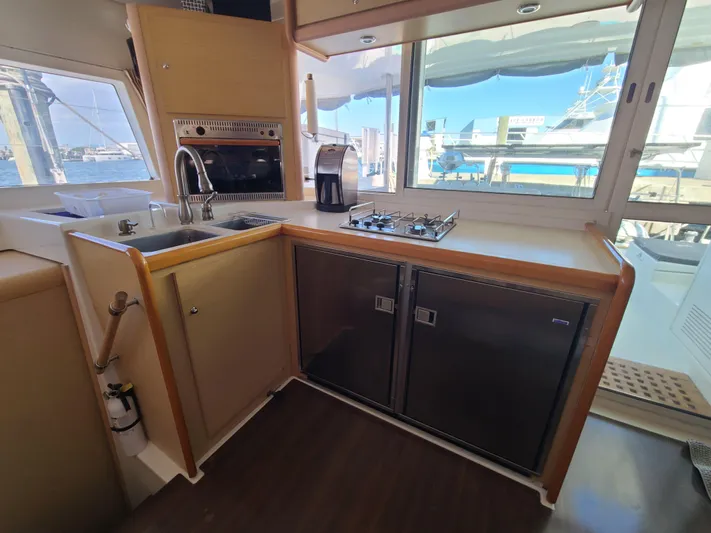 The Next Thing Yacht Photos Pics Interior of 2010 Lagoon 400 yacht kitchen with sink, stove, and refrigerator.