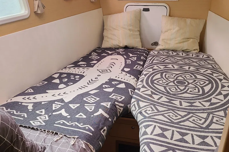 The Next Thing Yacht Photos Pics Cozy cabin interior of 2010 Lagoon 400 owner's version with patterned bedding.