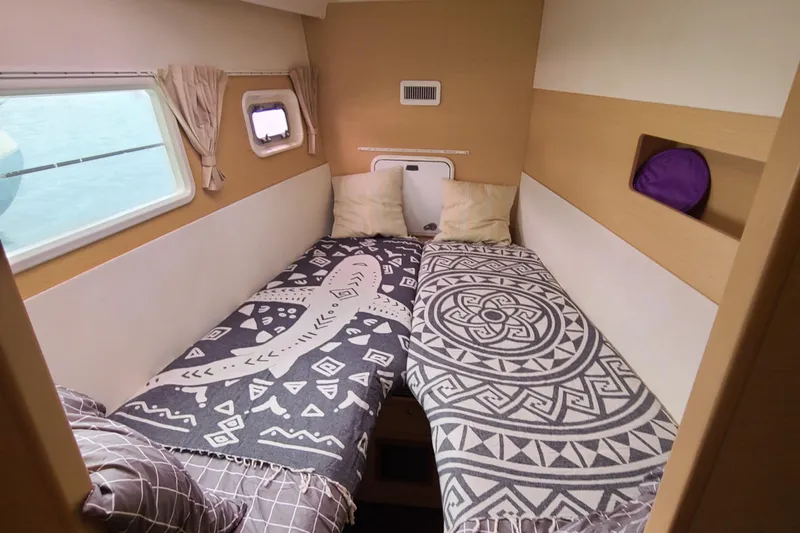 The Next Thing Yacht Photos Pics Cozy bedroom in 2010 Lagoon 400 owner's version catamaran with patterned bedding.