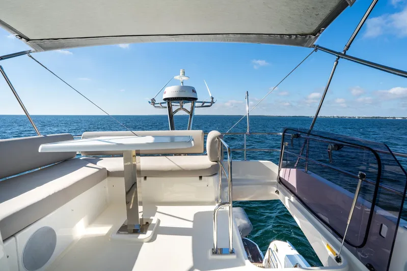Living Out Loud Yacht Photos Pics Prestige 420 yacht deck, 2020 model, overlooking the ocean under a clear blue sky.