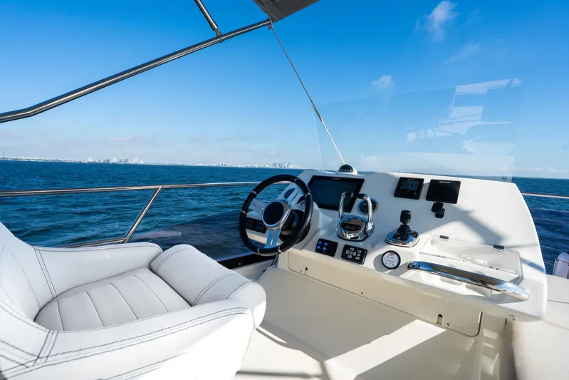 Living Out Loud Yacht Photos Pics Prestige 420 yacht helm, 2020 model, with ocean view and clear blue sky.