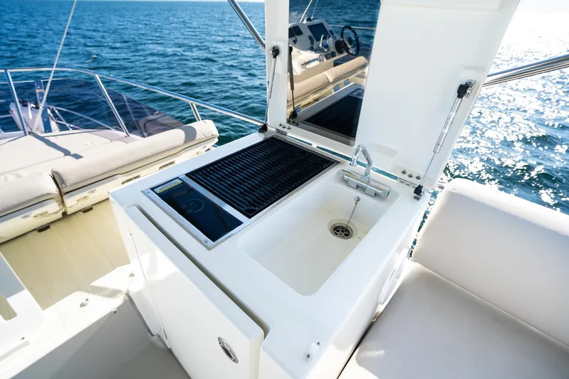 Living Out Loud Yacht Photos Pics Prestige 420 yacht outdoor kitchen with sink and grill, 2020 model, on open water.