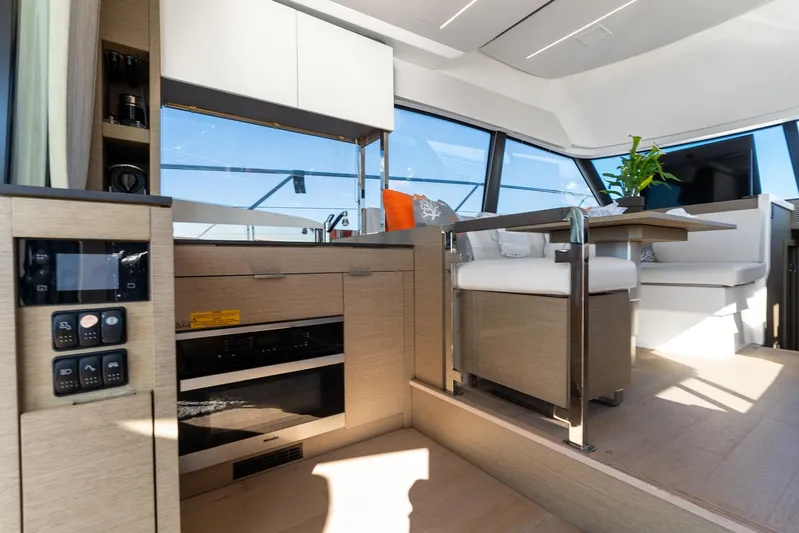 Living Out Loud Yacht Photos Pics Luxurious interior of 2020 Prestige 420 yacht with modern kitchen and seating area.