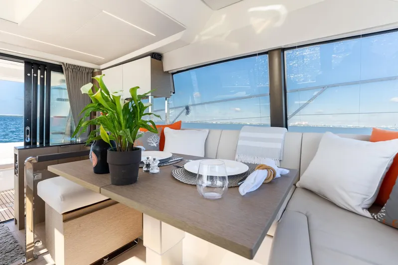 Living Out Loud Yacht Photos Pics Luxurious interior of 2020 Prestige 420 yacht with elegant dining setup and ocean view.