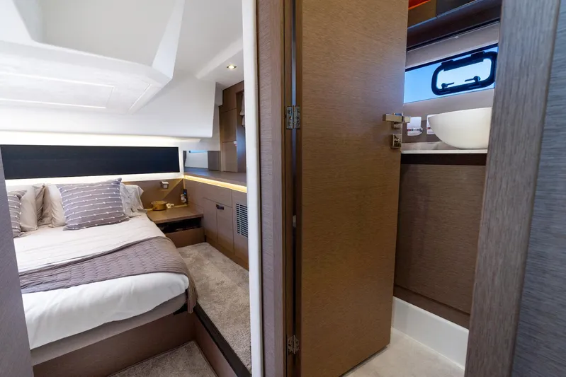 Living Out Loud Yacht Photos Pics Luxurious interior of 2020 Prestige 420 yacht featuring bedroom and bathroom.