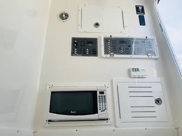  Yacht Photos Pics Control panel and microwave on 2020 SeaHunter 39 Tournament boat interior.