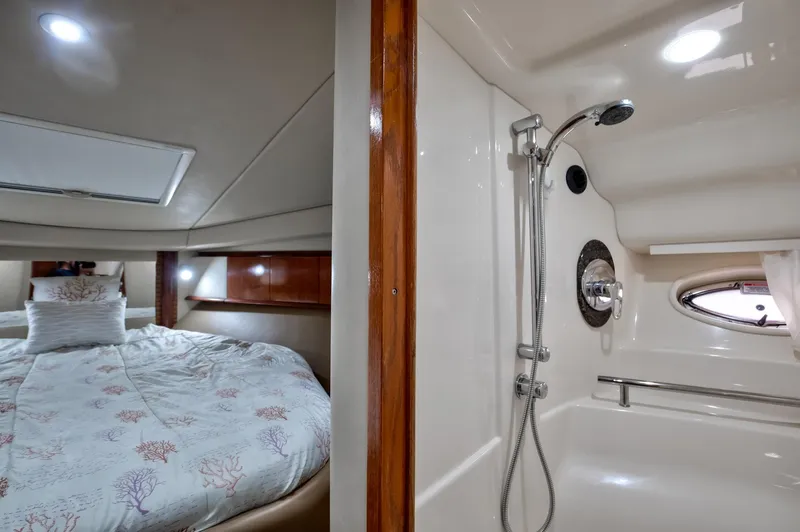 Sarah Jane III Yacht Photos Pics Interior of 2005 Sea Ray 390 Sundancer with bed and shower area.