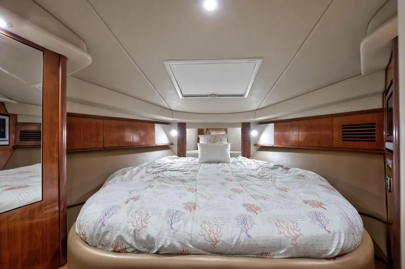 Sarah Jane III Yacht Photos Pics Luxurious cabin interior of 2005 Sea Ray 390 Sundancer yacht with cozy bedding.