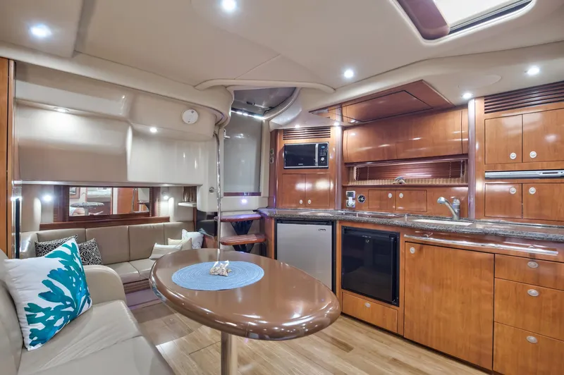 Sarah Jane III Yacht Photos Pics Luxurious interior of 2005 Sea Ray 390 Sundancer yacht with modern kitchen and seating area.