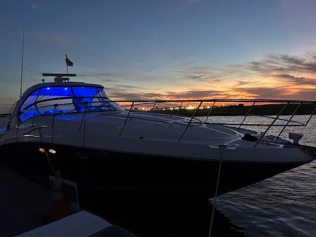 Sarah Jane III Yacht Photos Pics 2005 Sea Ray 390 Sundancer yacht at sunset with blue interior lights.