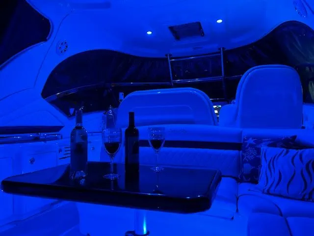 Sarah Jane III Yacht Photos Pics Luxurious 2005 Sea Ray 390 Sundancer interior with ambient blue lighting and wine setup.
