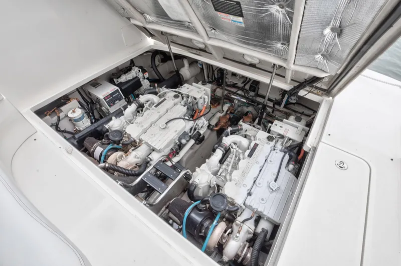 Sarah Jane III Yacht Photos Pics Engine compartment of 2005 Sea Ray 390 Sundancer, showcasing dual engines and mechanical components.