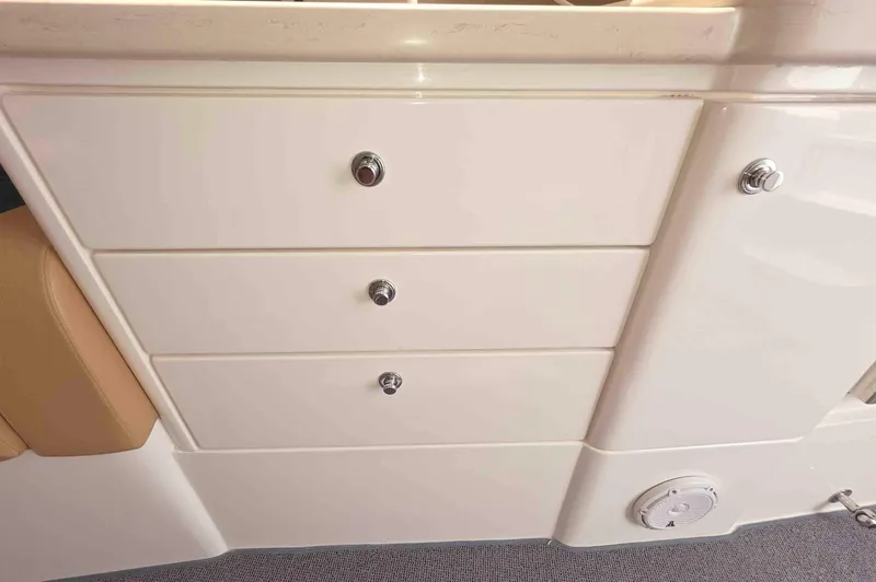  Yacht Photos Pics 2008 Intrepid 430 Sport Yacht interior with white storage drawers and beige seating.