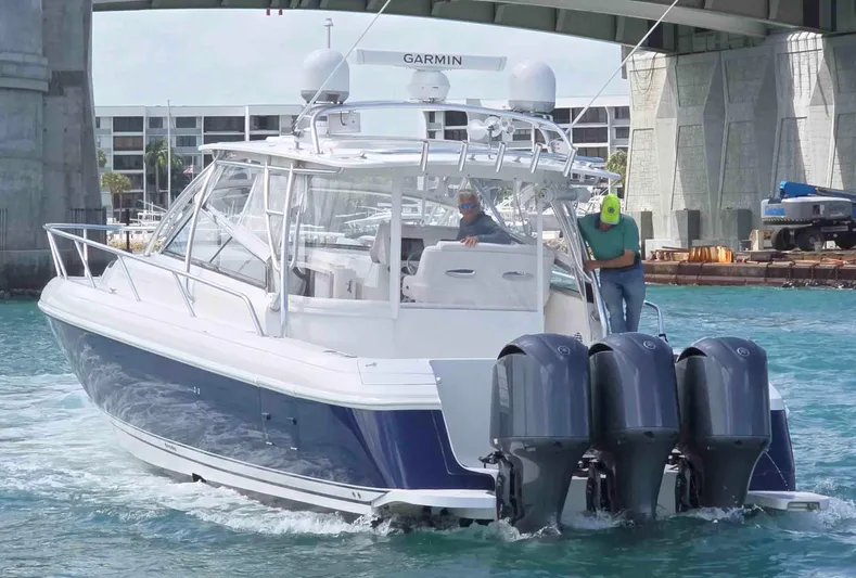  Yacht Photos Pics 2008 Intrepid 430 Sport Yacht cruising under a bridge with triple outboard engines.