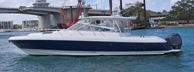  Yacht Photos Pics 2008 Intrepid 430 Sport Yacht on water near a bridge and construction site.