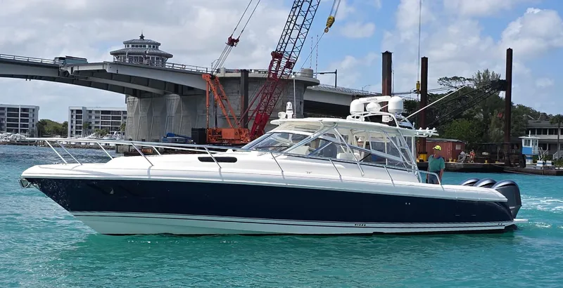  Yacht Photos Pics 2008 Intrepid 430 Sport Yacht cruising near a bridge on turquoise water.