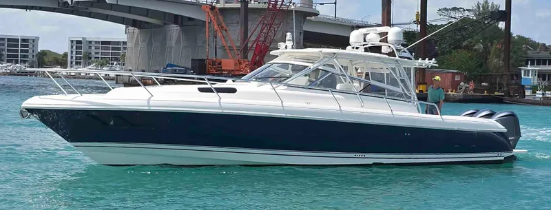  Yacht Photos Pics 2008 Intrepid 430 Sport Yacht cruising in turquoise waters near a bridge.