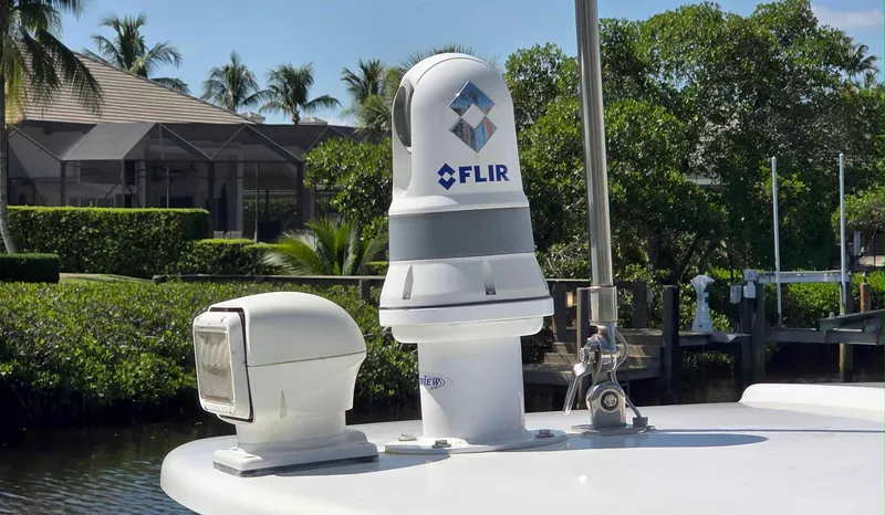  Yacht Photos Pics FLIR camera on 2008 Intrepid 430 Sport Yacht, docked near lush greenery.
