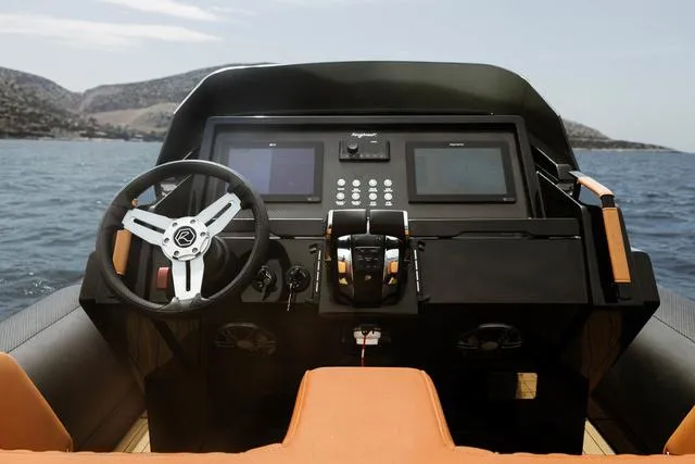  Yacht Photos Pics 2022 Roughneck RIB 1010 boat dashboard with steering wheel and navigation screens.