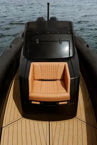  Yacht Photos Pics Roughneck RIB 1010 boat, 2022 model, featuring sleek design and tan seating on open water.