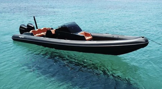  Yacht Photos Pics Roughneck RIB 1010 boat, 2022 model, floating on clear turquoise water.