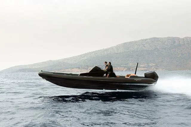  Yacht Photos Pics Roughneck RIB 1010 boat speeding on water, 2022 model, with mountainous backdrop.